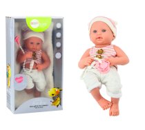 Baby doll in white and pink clothes, hat, pacifier, and blanket